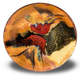 Wheel-thrown stoneware bowl in earth tone colors accented with red. Handmade pottery, Made in the U.S.A. by Prairie Fire Pottery. Overhead view of bowl.