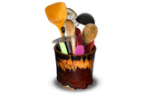 Beautiful toasted orange and red glaze colors on this cylinder spoon crock from Prairie Fire Pottery. Handmade pottery, wheel-thrown in stoneware clay. This is the view of the item holding kitchen utensils.
