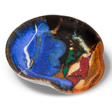 Beautiful milky blue spoon rest accented with toasted brown and red.  Hand made in stoneware clay and high-fired to 2400°.  It is handmade pottery from Prairie Fire Pottery.  3/4 view.