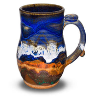 18 ounce stoneware mug in cobalt blue and toasted brown colors. Handmade pottery by Prairie Fire Pottery. Left side view.