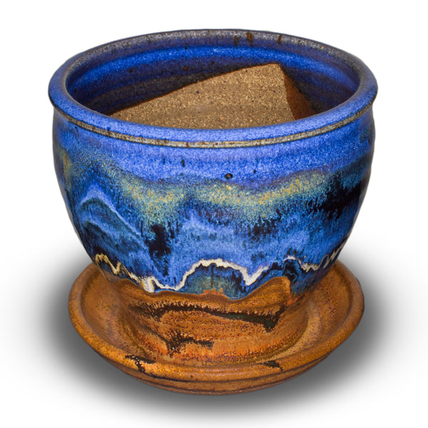 A small 5 inch stoneware planter in cobalt blue and toasted orange colors.  It's handmade pottery from Prairie Fire Pottery.  Made in the U.S.A.