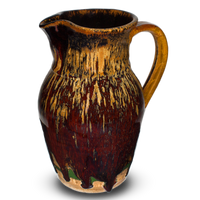 52 ounce handmade pottery pitcher in earth tones and red.  Wheel-thrown pottery fired to 2400° for strength and durability.  Hand made by Prairie Fire Pottery in the U.S.A.  Right side view.