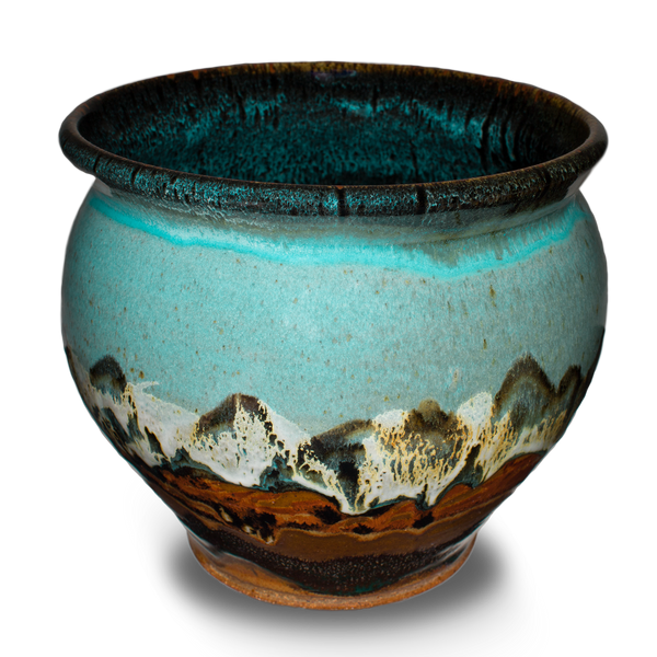 Soft turquoise and brown colors on a 7 inch handmade pottery spoon crock. Hand made by Prairie Fire Pottery. Hand crafted in stoneware clay and made in the U.S.A.