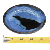 Small plate in light blue and black colors. Handmade pottery crafted in stoneware clay by Prairie Fire Pottery.  Side view with ruler.