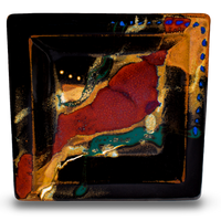 8 inch by 8 inch square plate with a bowl-like shape. Glazed in rich toasted brown and red against a deep black background. Handmade pottery by Prairie Fire Pottery. Kiln-fired to 2400°. Hand made in the U.S.A. Overhead view.