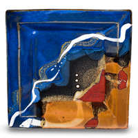 8 inch square plate. Cobalt blue and toasted brown colors, accented with red. Handmade pottery from Prairie Fire Pottery. This is a front-facing overhead view.