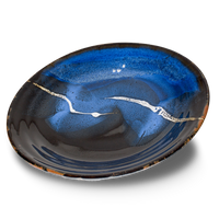 14 inch serving platter in cobalt blues and black. Handmade pottery by Prairie Fire Pottery. Hand made in the USA. 3/4 view.