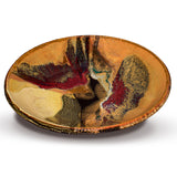 Beautiful handmade pottery bowl in earth tone colors accented with red.  Handmade pottery by Prairie Fire Pottery.  Made in the U.S.A.  Stoneware clay high-fired to 2400°.  3/4 view.