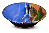 12 inch wheel-thrown pottery bowl in cobalt blue and toasted brown colors.  High-fired stoneware handmade by Prairie Fire Pottery.  This is a 3/4 view of the bowl.
