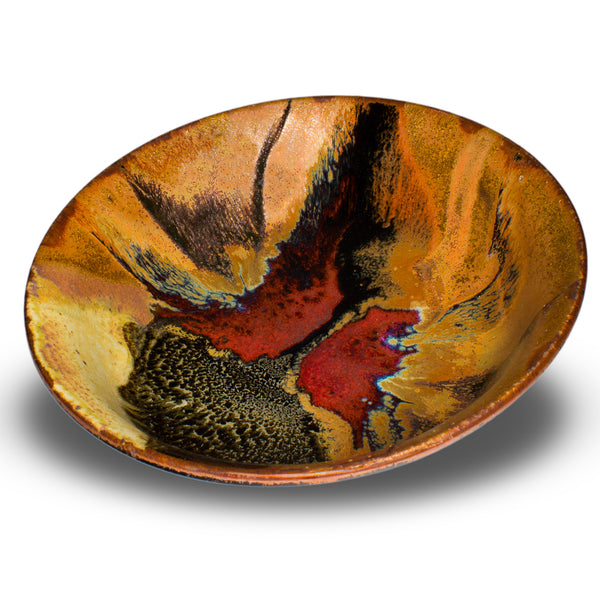 Wheel-thrown stoneware bowl in earth tone colors accented with red. Handmade pottery, Made in the U.S.A. by Prairie Fire Pottery. 3/4 view of bowl.
