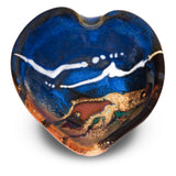 A handmade pottery heart bowl in beautiful cobalt blue colors accented with toasted brown and red. It is hand made in the U.S.A. by Prairie Fire Pottery. Overhead view.