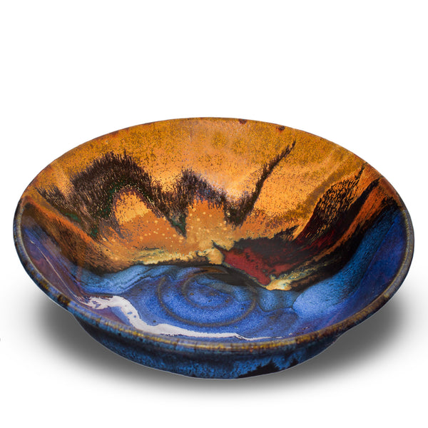Lovely 9 inch serving bowl in cobalt blue and toasted orange. Handmade pottery by Prairie Fire Pottery. Made in the U.S.A. 3/4 view.