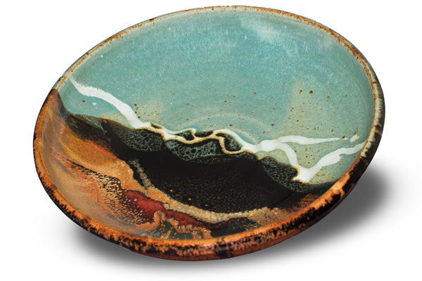 9-inch stoneware bowl. Toasted brown and turquoise colors. Handmade pottery. Stoneware clay. Hand made by Prairie Fire Pottery in U.S.A. 3/4 table top view.