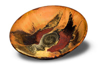 9.5 inch stoneware bowl in beautiful earth tone and red glaze colors. This is handmade pottery by Prairie Fire Pottery. It is hand made of wheel-thrown clay in the U.S.A. This is the 3/4 view of the bowl.