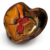 Heart-shaped bowl in toasted orange and black with red accents. Handmade pottery by Prairie Fire Pottery.  3/4 view.