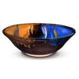 10 inch stoneware bowl from Prairie Fire Pottery.  It is wheel-thrown and high-fired to 2400 degrees.  It is glazed in beautiful cobalt blue over toasted brown  accented with ribbons of white and gold.  This the side view of the bowl.