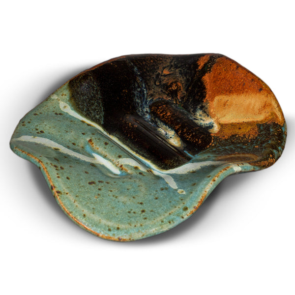 Handmade pottery soap dish by Prairie Fire Pottery.  Hand made in stoneware clay and glazed in turquoise and brown colors.  This is a 3/4 view of the soap dish.