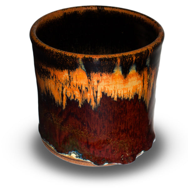 Beautiful toasted orange and red glaze colors on this cylinder spoon crock from Prairie Fire Pottery.  Handmade pottery, wheel-thrown in stoneware clay.  This is the 3/4 view of the item.