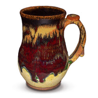 This is the right side view of a stoneware mug in beautiful earth tone and brillant red colors.  It is handmade pottery by Prairie Fire Pottery.
