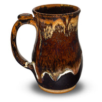 Wheel-thrown stoneware mug. 18 ounce. Handmade pottery by Prairie Fire Pottery. Beautiful earth tone and red glazes.  Left side view.