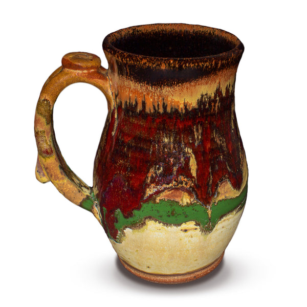 Gorgeous handmade takard mug in earth tone and red colors.  Handmade pottery.  Hand made by Prairie Fire Pottery in stoneware clay fired to 2400°.  Left side view.