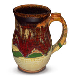 Gorgeous handmade takard mug in earth tone and red colors.  Handmade pottery.  Hand made by Prairie Fire Pottery in stoneware clay fired to 2400°.  Right side view.