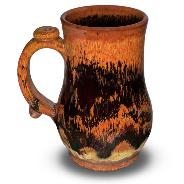 16 ounce Prairie Fire Pottery stoneware mug in earth tone colors and red. Handmade pottery that is wheel-thrown and high-fired to 2400°. Hand made in the U.S.A.  Left side view