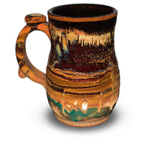 16 ounce stoneware mug.  Handmade pottery by Prairie Fire Potterey.  Earth tone  colorss with red and green accents.  Hand made in the U,S.A.  Left side view.