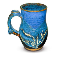 This is an 18-ounce wheel-thrown ceramic mug in cobalt blue and black glaze colors.  It is handmade pottery by Prairie Fire Pottery.  Hand made in the U.S.A.  This view is of the left side of the mug.