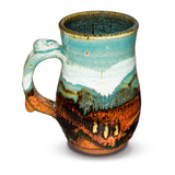 Stoneware mug. Handmade pottery. Turquoise-Brown color combination. Hand made by Prairie Fire Pottery.  Made in the U.S.A.   Left side view.