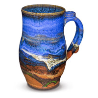 24 ounce handmade pottery mug in cobalt blue and toasted brown. Wheel-thrown and high-fired to 2400° by Prairie Fire Pottery. Will quickly become your favorite morning coffee cup.  Right sideview.