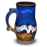 Handmade pottery mug in cobalt blue and toasted brown. Wheel-thrown and high-fired to 2400° by Prairie Fire Pottery. Will quickly become your favorite morning coffee cup.  Left sideview.