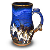 20 ounce handmade pottery mug in cobalt blue and toasted brown. Wheel-thrown and high-fired to 2400° by Prairie Fire Pottery. Will quickly become your favorite morning coffee cup.  Right side view.