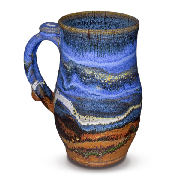 24 ounce handmade pottery mug in cobalt blue and toasted brown. Wheel-thrown and high-fired to 2400° by Prairie Fire Pottery. Will quickly become your favorite morning coffee cup.  Left sideview.
