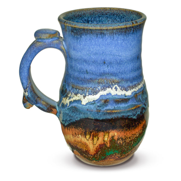 Handmade pottery mug in cobalt blue and toasted brown. Wheel-thrown and high-fired to 2400° by Prairie Fire Pottery. Will quickly become your favorite morning coffee cup.  Left sideview.