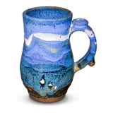 Handmade pottery mug in cobalt blue and toasted brown. Wheel-thrown and high-fired to 2400° by Prairie Fire Pottery. Will quickly become your favorite morning coffee cup.   This is the right side view.