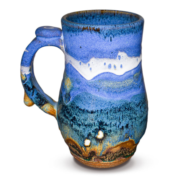 Handmade pottery mug in cobalt blue and toasted brown. Wheel-thrown and high-fired to 2400° by Prairie Fire Pottery. Will quickly become your favorite morning coffee cup.  