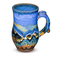 16 ounce Handmade pottery mug in cobalt blue and toasted brown. Wheel-thrown and high-fired to 2400° by Prairie Fire Pottery. Will quickly become your favorite morning coffee cup.  This is the right side view.