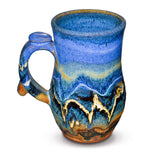 16 ounce Handmade pottery mug in cobalt blue and toasted brown. Wheel-thrown and high-fired to 2400° by Prairie Fire Pottery. Will quickly become your favorite morning coffee cup.  This is the left side view.