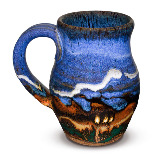This is a 14 ounce wheel-thrown stoneware mug in earth tone and cobalt blue colors.  It is handmade pottery by Prairie Fire Pottery.  This is a side view of the mug.