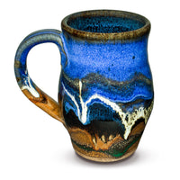 This is a 14 ounce wheel-thrown stoneware mug in earth tone and cobalt blue colors.  It is handmade pottery by Prairie Fire Pottery.  This is a side view of the mug.