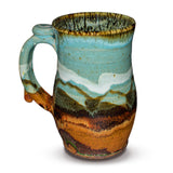 Handmde 24 ounce pottery mug.  Turquoise and brown colors.  Hand made by Prairie Fire Pottery.  Left side view.