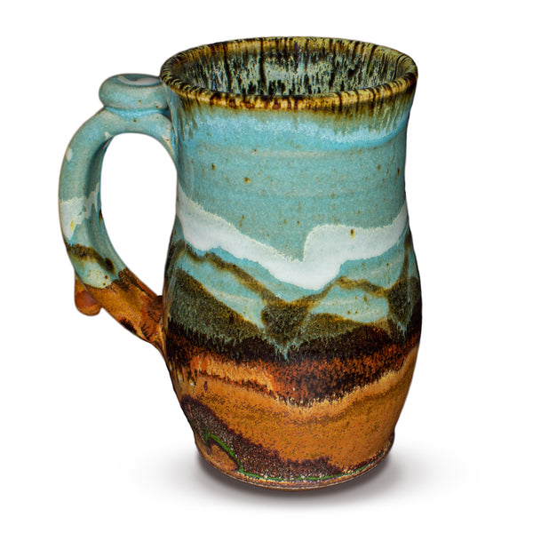 Handmde 24 ounce pottery mug.  Turquoise and brown colors.  Hand made by Prairie Fire Pottery.  Left side view.