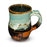 Turquoise and brown stoneware mug. Wheel-thrown. Handmade pottery by Prairie Fire Pottery. 12 ounce size.  This  is the right side view.