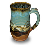 Handmde 20 ounce pottery mug.  Turquoise and brown colors.  Hand made by Prairie Fire Pottery.  Right side view.