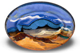 Handmade pottery by Prairie Fire Pottery. 9-inch oval stoneware plate in cobalt blue and toasted orange colors. Accented with red and teal. Hand made in the U.S.A. Overhead view.