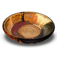 This is a pretty six inch garlic dipping plate in earth tone colors and red.   It has a raspy spiral center for breaking up garlic cloves before adding oil and vinegar.  Handmade pottery by Prairie Fire Pottery.