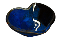 Cobalt blue and black bowl in the shape of a heart.  It's handmade pottery from Prairie Fire Pottery.  Hand made in stoneware clay.  3/4 view.