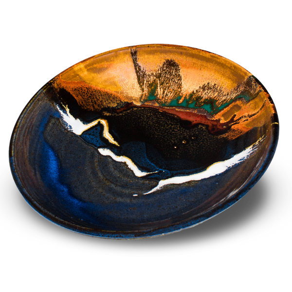 9 inch stoneware bowl in pretty toasted orange and cobalt blue colors. Hand made and wheel-thrown by Prairie Fire Pottery. Handmade pottery made in the U.S.A. 3/4 view of the bowl.