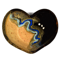 Stoneware heart bowl in yellow and black colors.  Handmade pottery by Prairie Fire Pottery.  Hand made in the U.S.A.  Overhead  view.